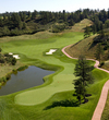 The par-5 15th hole at The Sanctuary golf course in Sedalia, Colorado. The green is protected by a narrow approach and water on the right side.