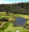 The par-3 14th hole at The Sanctuary golf course demands a careful tee shot to clear the water.